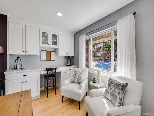 living area featuring built in desk and light hardwood / wood-style floors