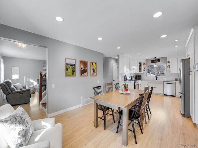 dining space featuring light hardwood / wood-style floors