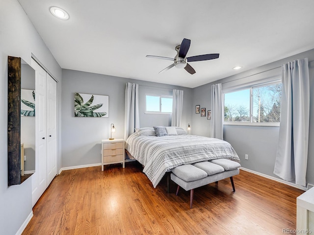 bedroom featuring ceiling fan, wood-type flooring, and a closet