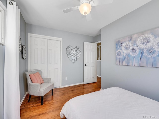 bedroom with hardwood / wood-style flooring, ceiling fan, and a closet