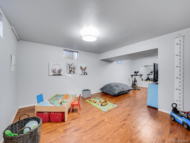 bedroom featuring hardwood / wood-style floors and a textured ceiling