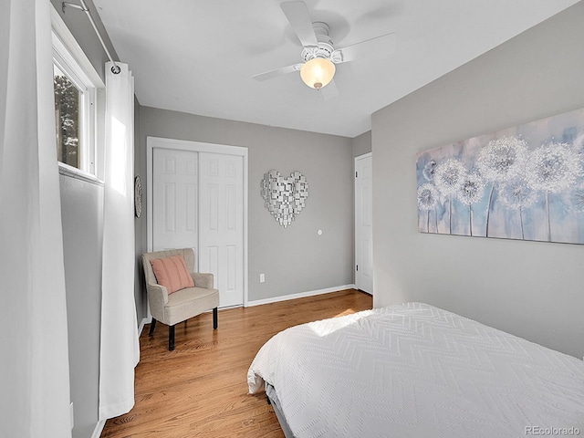 bedroom featuring hardwood / wood-style floors, ceiling fan, and a closet