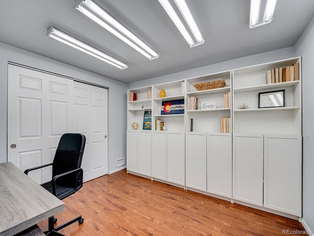 unfurnished office with light hardwood / wood-style floors