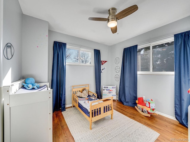 bedroom with hardwood / wood-style flooring and ceiling fan