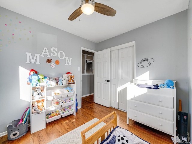 bedroom featuring hardwood / wood-style floors, ceiling fan, and a closet