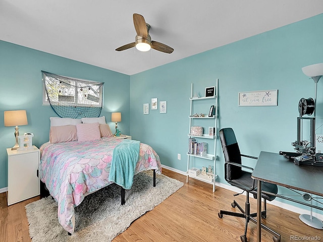 bedroom with hardwood / wood-style flooring and ceiling fan