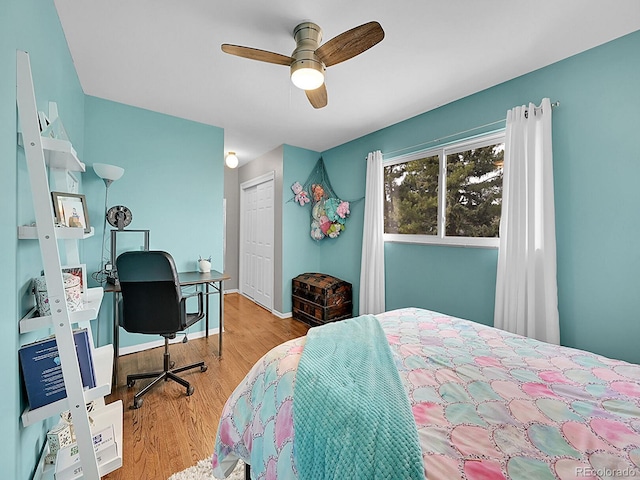 bedroom featuring light hardwood / wood-style floors, a closet, and ceiling fan