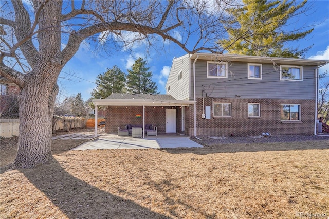 rear view of property featuring a patio area and outdoor lounge area