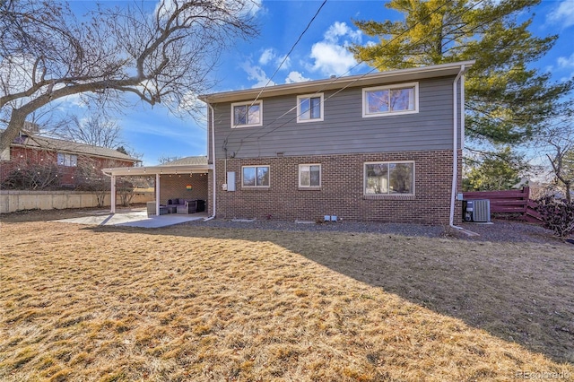 back of property with a patio area, central air condition unit, and a lawn