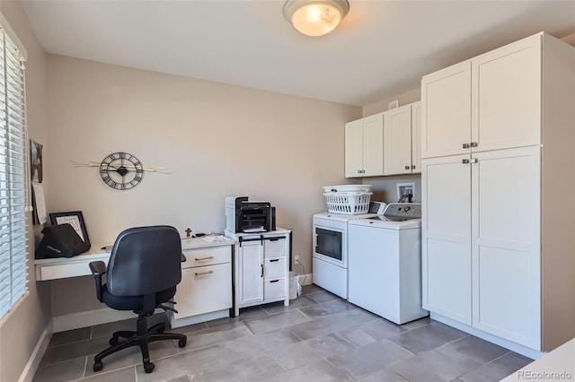 clothes washing area with cabinets, plenty of natural light, and washer and clothes dryer