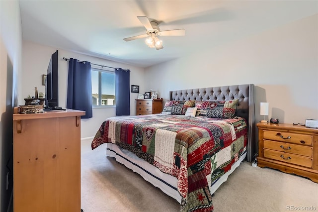 bedroom featuring ceiling fan and light carpet