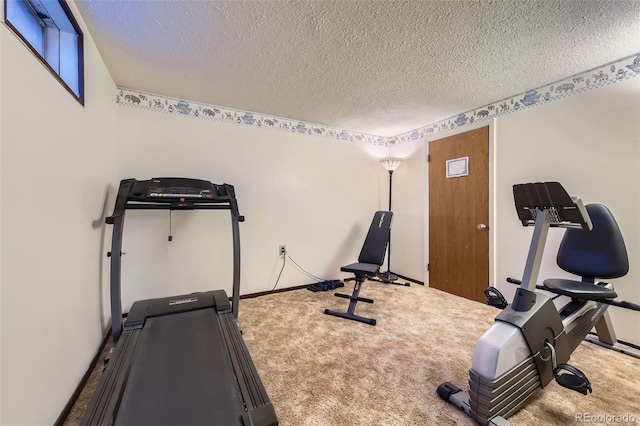 exercise area with a textured ceiling and carpet floors