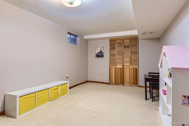 rec room with light colored carpet