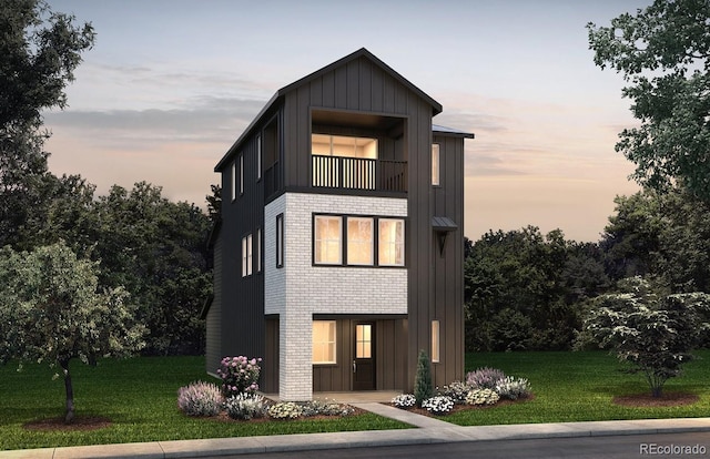 8625 Hotchkiss St, Littleton, CO 80125 - contemporary house featuring board and batten siding, a balcony, a lawn, and brick siding