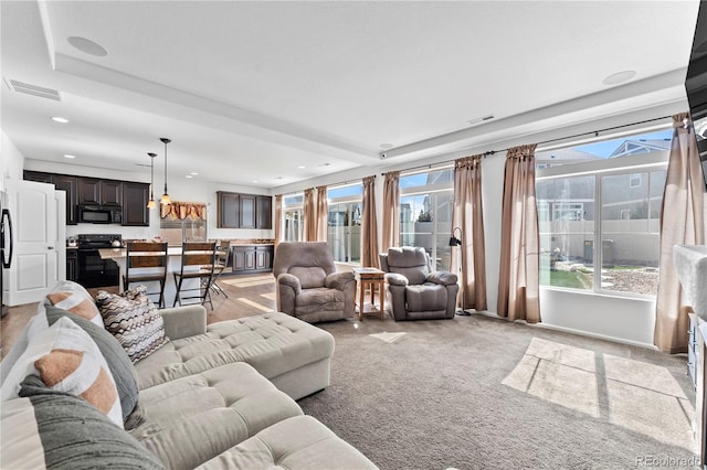 living room with recessed lighting and visible vents