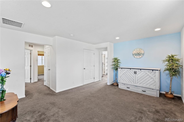 interior space with carpet flooring, recessed lighting, visible vents, and baseboards