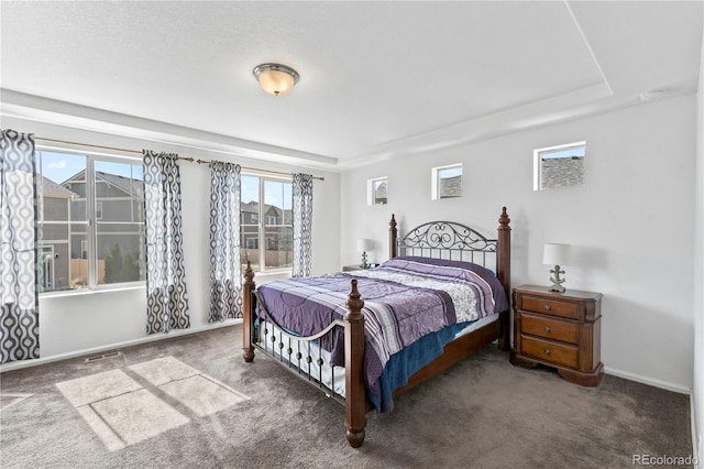 carpeted bedroom with visible vents and baseboards