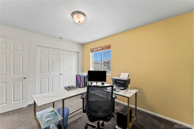 home office featuring baseboards, carpet, and a textured ceiling