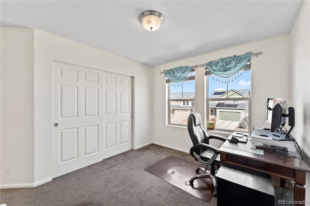 carpeted office featuring baseboards