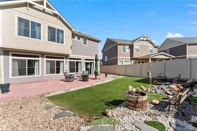 rear view of property with a yard, a patio area, and fence