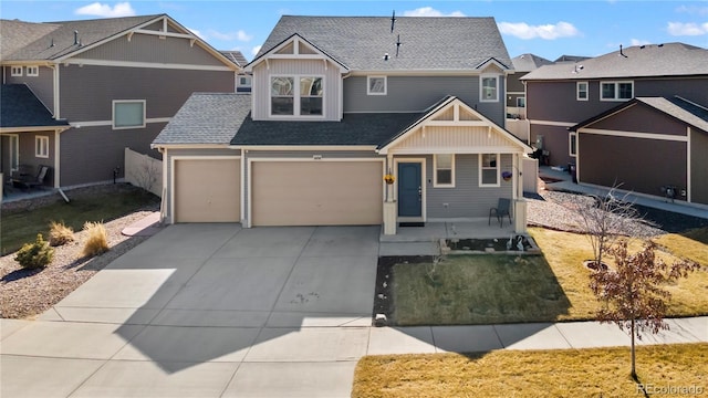 craftsman-style house with a residential view, concrete driveway, board and batten siding, a shingled roof, and a porch