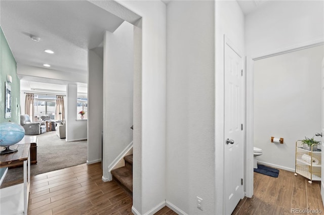 hall with stairway, wood finished floors, baseboards, and recessed lighting