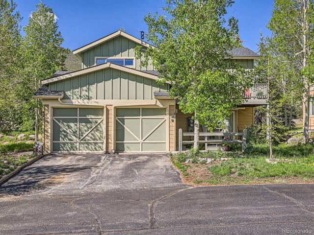 40 Cove Blvd Unit G40, Dillon, CO 80435 - view of front of home featuring asphalt driveway, a garage, and board and batten siding