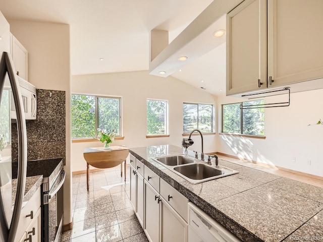 40 Cove Blvd Unit G40, Dillon, CO 80435 - kitchen with a sink, white appliances, vaulted ceiling, tile countertops, and baseboards