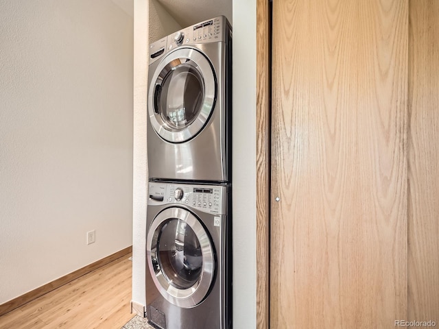 40 Cove Blvd Unit G40, Dillon, CO 80435 - laundry area with stacked washer and clothes dryer, wood finished floors, and baseboards