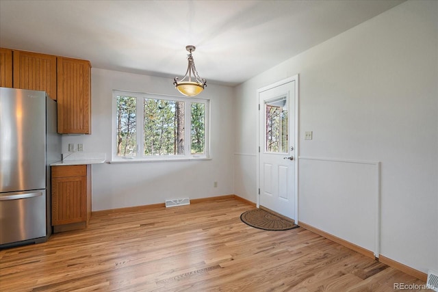 29827 Gigi Rd, Evergreen, CO 80439 - unfurnished dining area featuring light wood-style flooring and baseboards