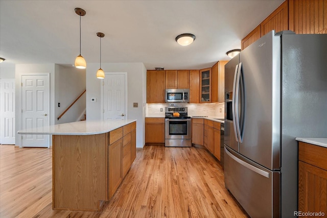 29827 Gigi Rd, Evergreen, CO 80439 - kitchen with stainless steel appliances, brown cabinetry, and light wood-style flooring