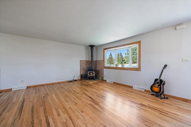 29827 Gigi Rd, Evergreen, CO 80439 - unfurnished living room with a wood stove and wood finished floors