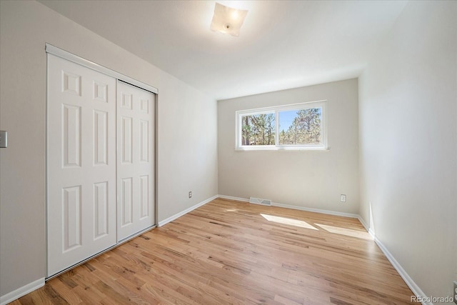 29827 Gigi Rd, Evergreen, CO 80439 - unfurnished bedroom featuring light wood-style flooring and a closet