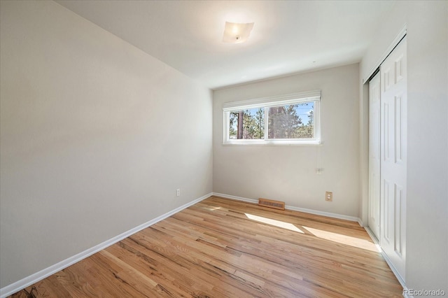 29827 Gigi Rd, Evergreen, CO 80439 - unfurnished bedroom featuring light wood-type flooring and a closet