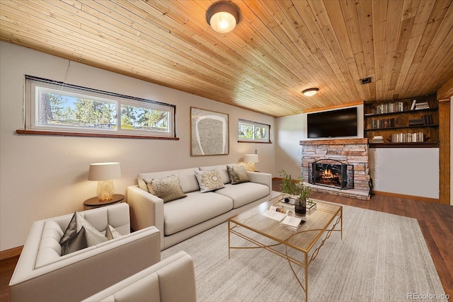 29827 Gigi Rd, Evergreen, CO 80439 - living area featuring wooden ceiling, wood finished floors, and a stone fireplace