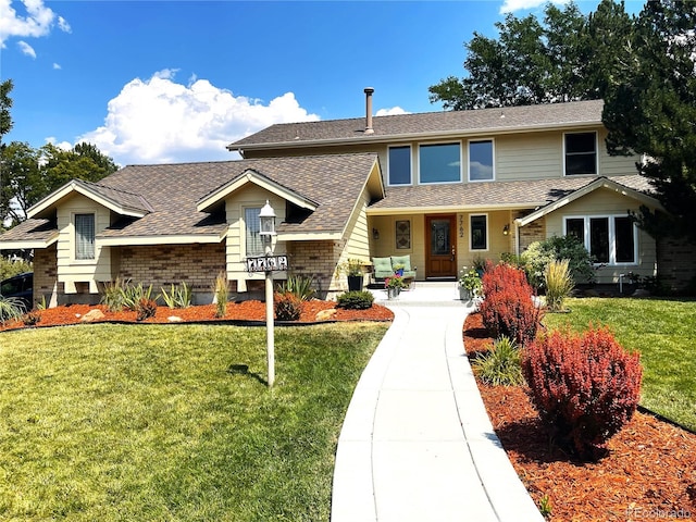 view of front of house with a front yard and covered porch