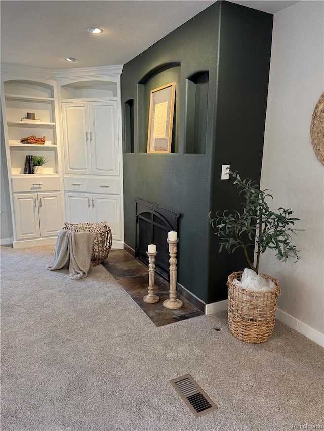 interior space with dark carpet and built in shelves