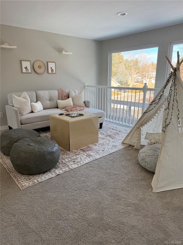 living room with carpet floors and plenty of natural light