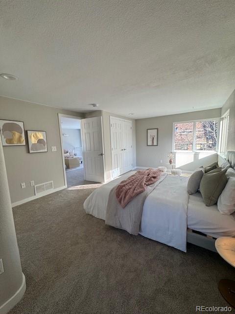 carpeted bedroom with a textured ceiling