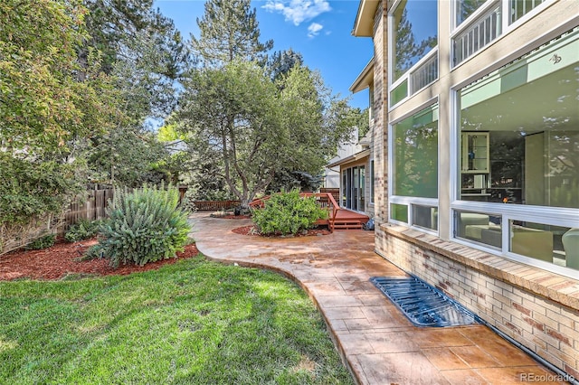 view of yard featuring a deck and a patio area