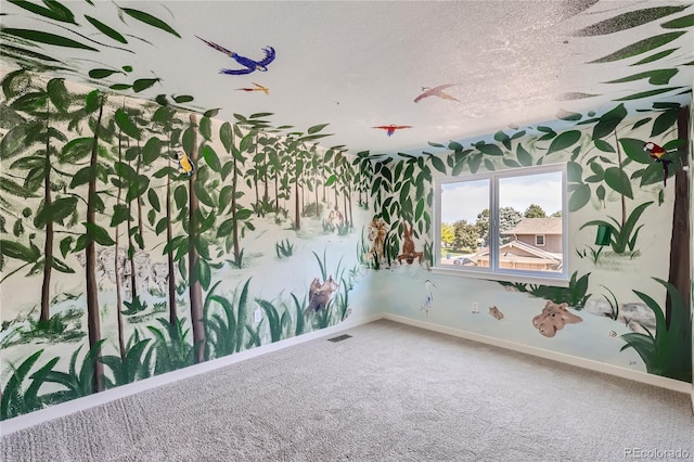 carpeted spare room featuring a textured ceiling