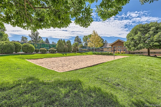 view of home's community with a lawn and volleyball court