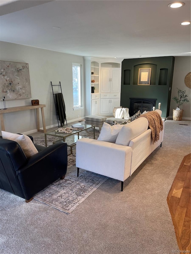 carpeted living room featuring a fireplace