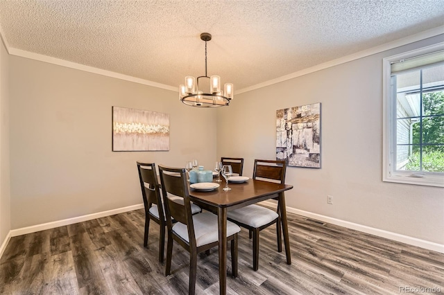 16257 E Belleview Pl, Centennial, CO 80015 - dining space with a textured ceiling, a chandelier, dark wood-style flooring, ornamental molding, and baseboards