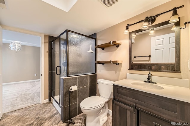 16257 E Belleview Pl, Centennial, CO 80015 - full bath with toilet, vanity, a stall shower, baseboards, and wood finished floors