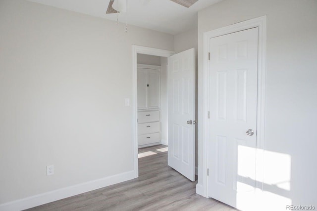 unfurnished bedroom with baseboards and light wood-style floors