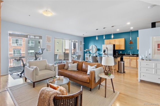 living area with recessed lighting and light wood-style flooring