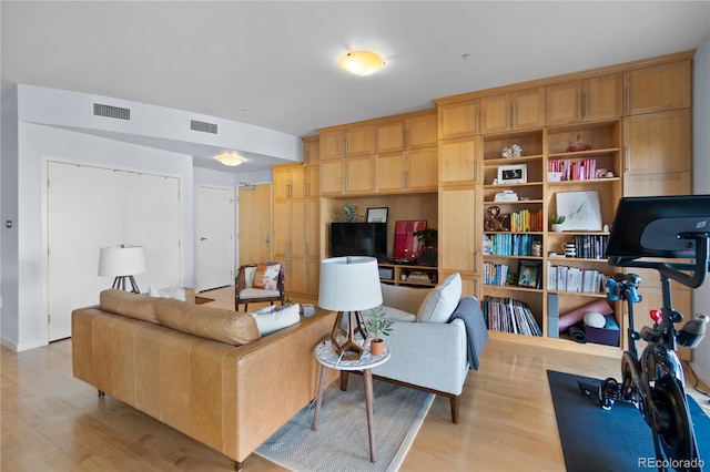 living room featuring visible vents and light wood-type flooring