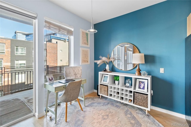 office space with baseboards and wood finished floors