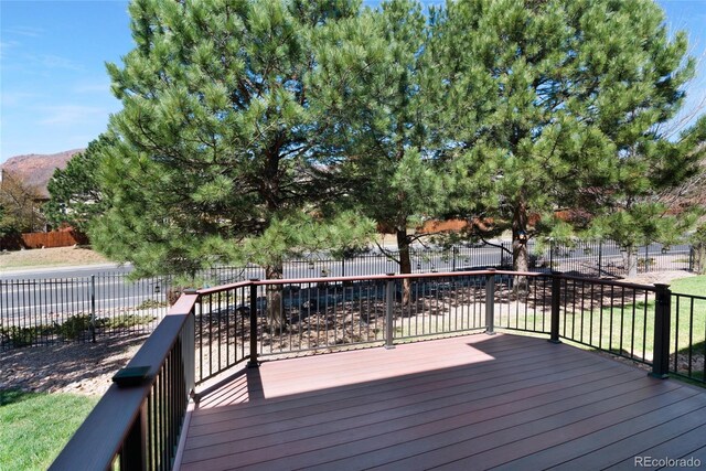 7436 Centennial Glen Dr, Colorado Springs, CO 80919 - wooden terrace featuring a fenced backyard and a mountain view